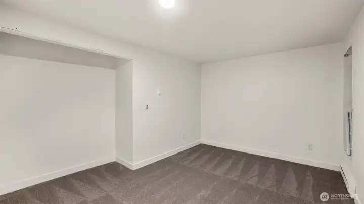 Another sizable guest bedroom with open closet.
