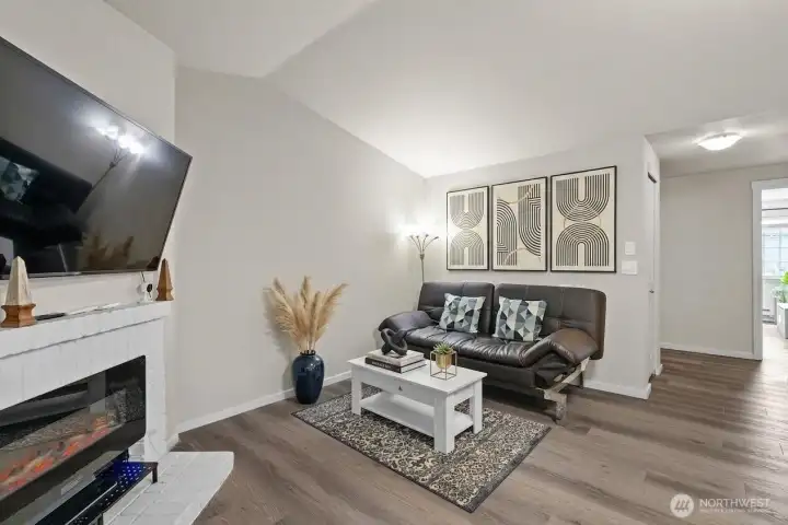 Bright, fully renovated living room with cozy fireplace in this move-in-ready condo at Bluegrass Condominiums, 12404 E Gibson Rd, Everett WA — fresh paint and updated flooring set this unit apart from others in the complex.