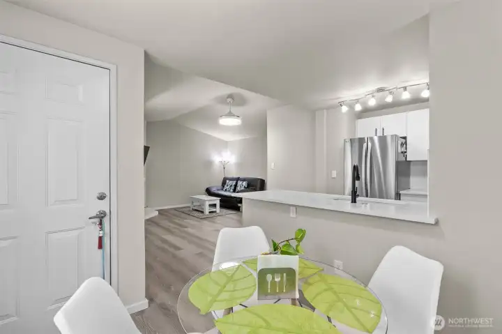 Welcoming entry flows into an open dining area, showcasing the fresh paint and updates throughout this Mukilteo School District condo.