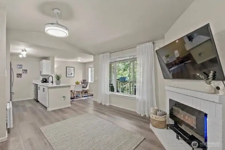 Open-concept living and dining space with fireplace, ideal for entertaining in this fully updated 2-bed, 2-bath Everett condo.