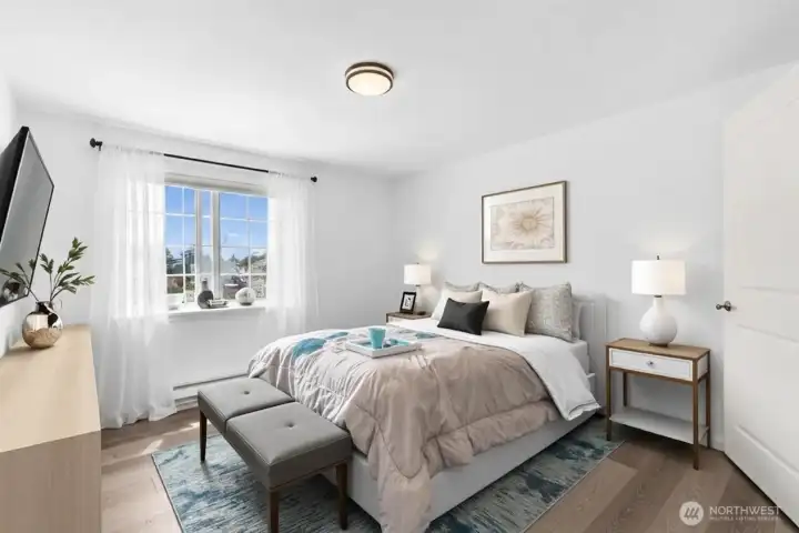 Spacious primary bedroom with plush carpet and natural light, freshly updated to move-in-ready condition.