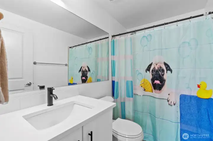 Second full bathroom with updated vanity and fixtures, offering convenience for family or guests.