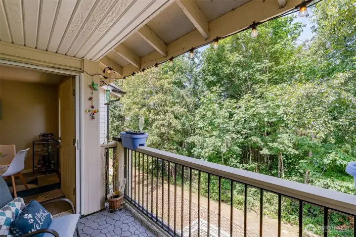 Additional balcony view highlighting the peaceful, tree-lined setting of this top-floor Bluegrass Condominiums unit.