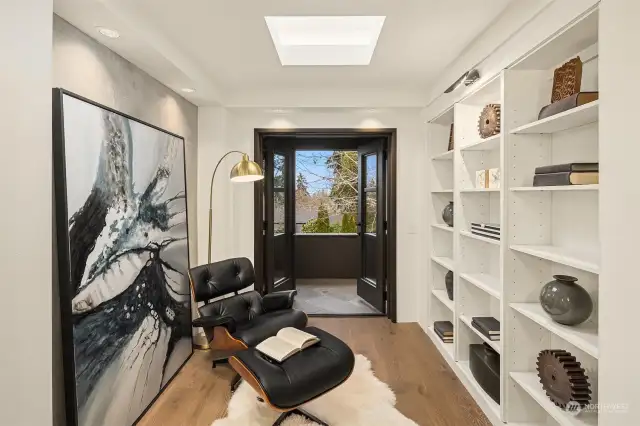 Upstairs office/reading nook space opening to private balcony.