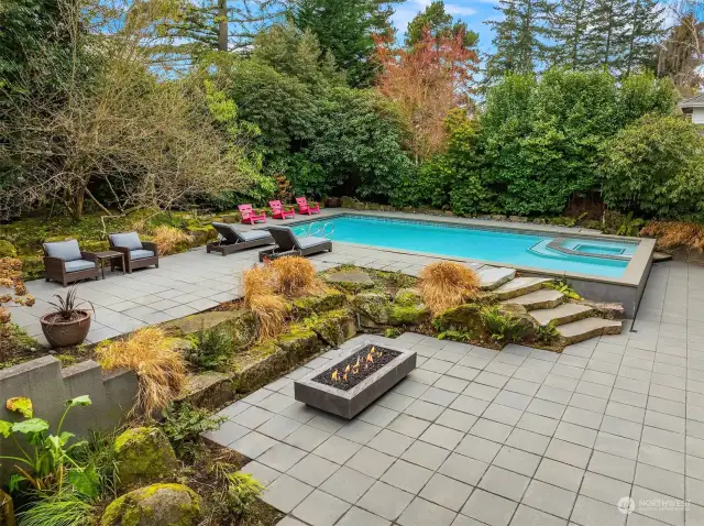 The outdoor spaces are equally well-designed, featuring a stunning pool, multiple patios for entertaining or relaxation, and a detached office/studio that provides both functionality and charm.