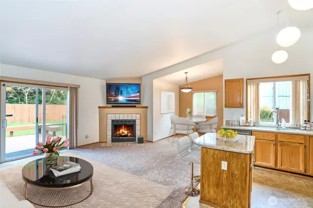 Vaulted ceilings, sliding glass door to deck, fireplace and open concept kitchen and family room.