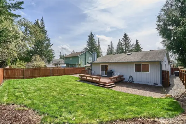 View of Back yard with fully fenced yard and deck.