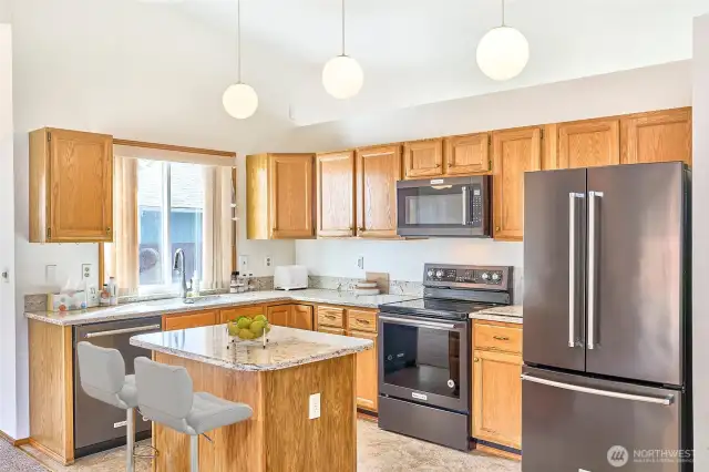 Kitchen with new stainless steel appliances.