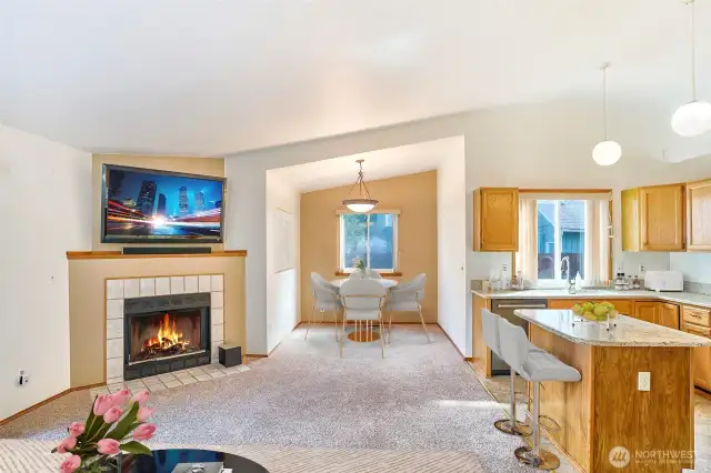 Wood fireplace, dining area and kitchen.
