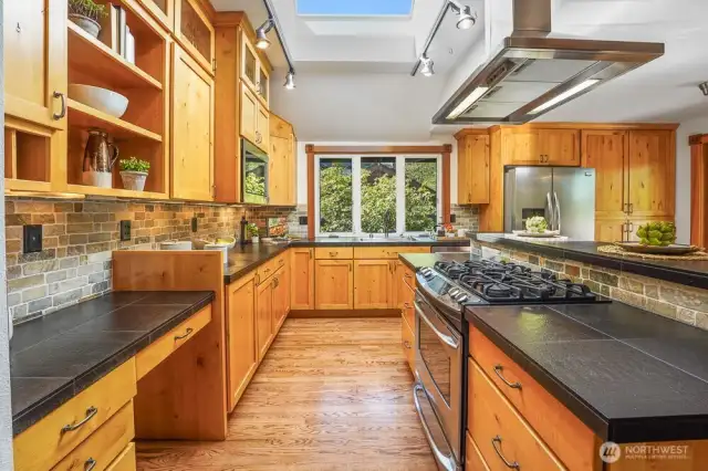 Updated Chef's kitchen includes SS steel appliances, gas stove, granite countertops, and solid wood cabinets.