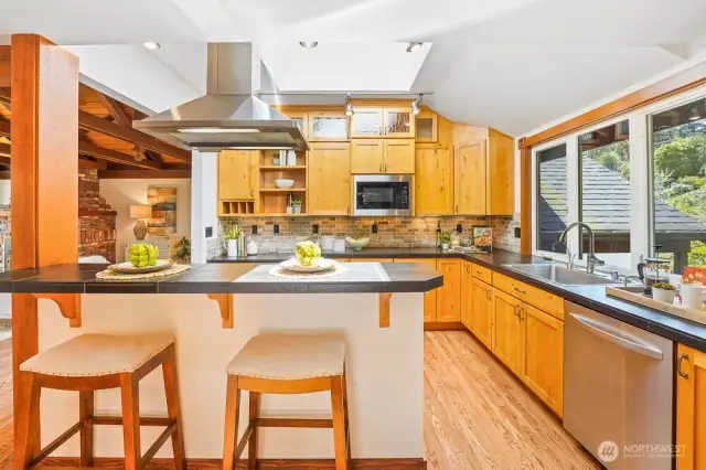 Updated Chef's kitchen includes SS steel appliances, gas stove, granite countertops, and solid wood cabinets.