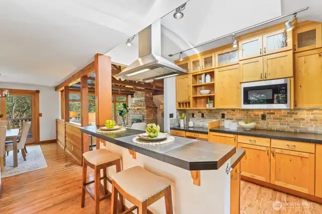 Updated Chef's kitchen includes SS steel appliances, gas stove, granite countertops, and solid wood cabinets.