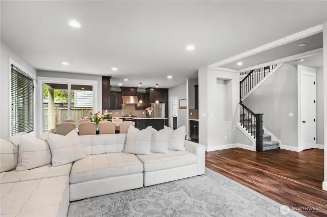 Massive open-concept layout unites kitchen, dining, and living—flooded with natural light.