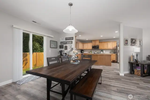 A designated dining area sits just off the kitchen, ideal for everyday meals or hosting holiday gatherings. Patio door windows bring in even more light.