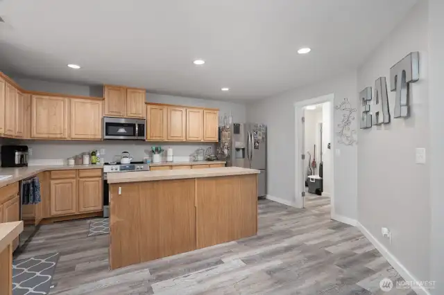 Another view of the kitchen island showcases its large surface—ideal for food prep, homework, or casual meals.