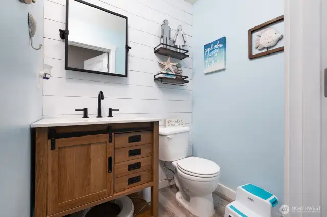 An inviting half bath on the main level features upgraded finishes and is perfectly positioned for guests.