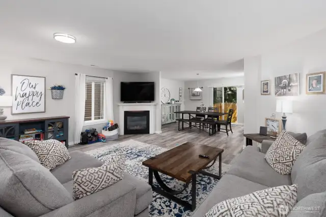 Main floor living space viewed from the stairway highlights the flow and modern finishes throughout.