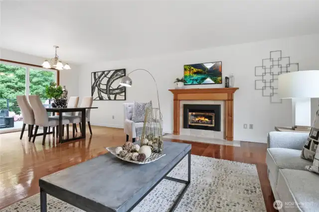 The spacious living room, complete with a cozy gas fireplace, is perfect for gatherings or quiet evenings