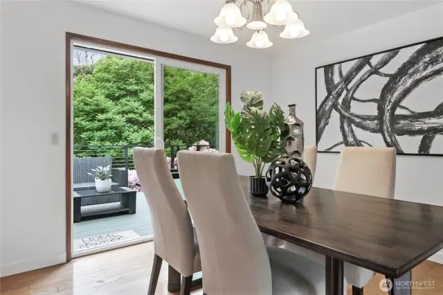 A sliding glass door leads outside to the expansive deck overlooking the beautiful backyard.