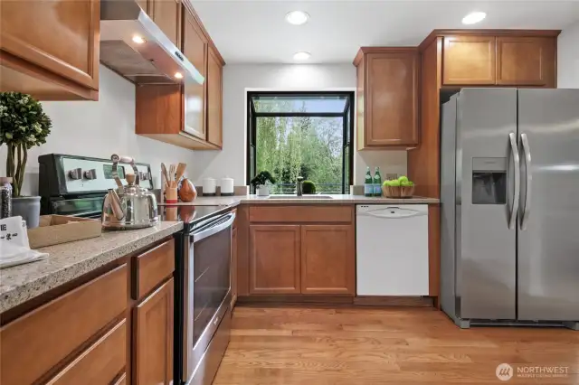 The refreshed Kitchen features oak cabinets, and quartz counter tops.