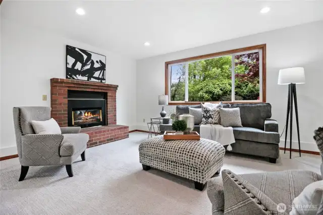 Lower level bonus/family room with plenty of room to play and relax, complete with a cozy gas fireplace and direct sliding glass door access to the side yard deck.