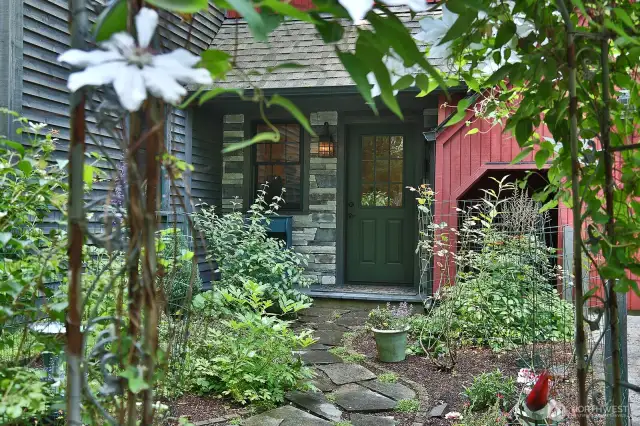 Welcome! A covered front porch entry greets you. All period lighting is special ordered and hand made. All cedar siding has been stained. All interior and exterior wood doors are custom made. Let's go inside......