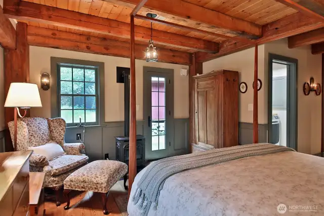 Another view of the Primary Suite. The glass paned door leads to the Southern side of your home. You can see the laundry room through the open door to the right edge of this photo.