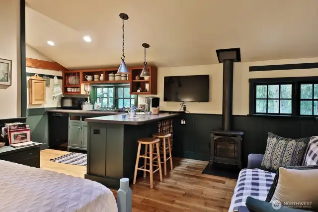 Kitchen area with a cooktop & dishwasher. Cozy up to the propane stove.  Such a well designed space!