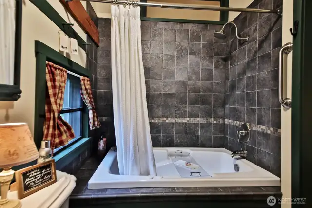 Jacuzzi soaking tub with a view of the gorgeous forest that surrounds you.