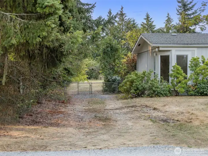 Gravel driveway to backyard and detached shop/garage/RV parking