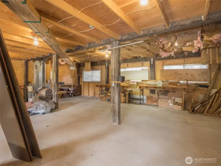With built-in shelving, multiple workbenches, and ample floor space, the shop/garage is ideal for woodworking, mechanical work, or hobby crafting.