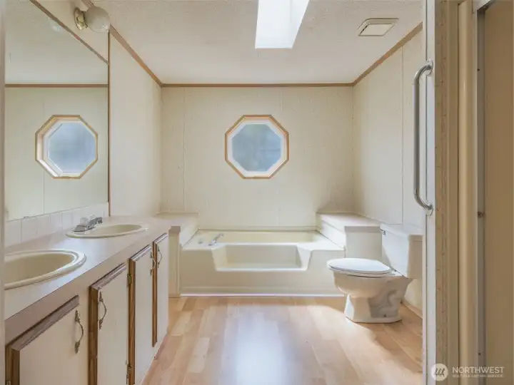 The en-suite bathroom features a deep soaking tub perfect for unwinding, a separate shower.