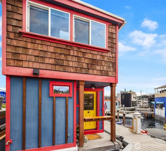 Thoughtful and practical details - such as a covered porch entry with a wide railing to rest groceries as you open the door ... or to set a beverage on as you greet neighbors on the dock.
