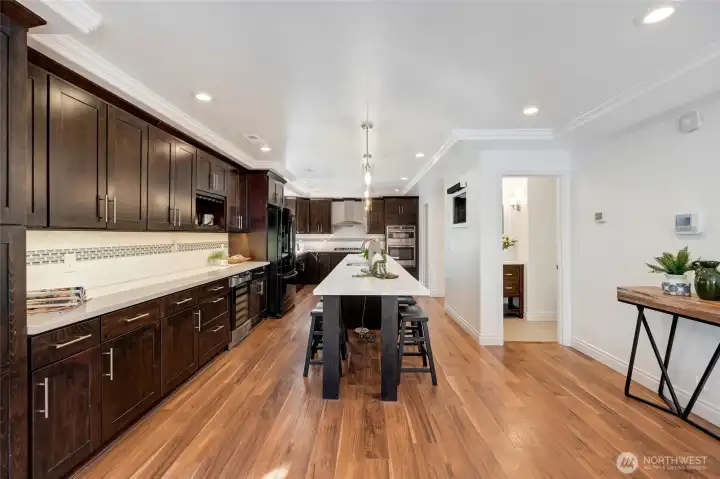 Gorgeous quartz counters, custom cabinetry, and built-in beverage fridge elevate every meal.
