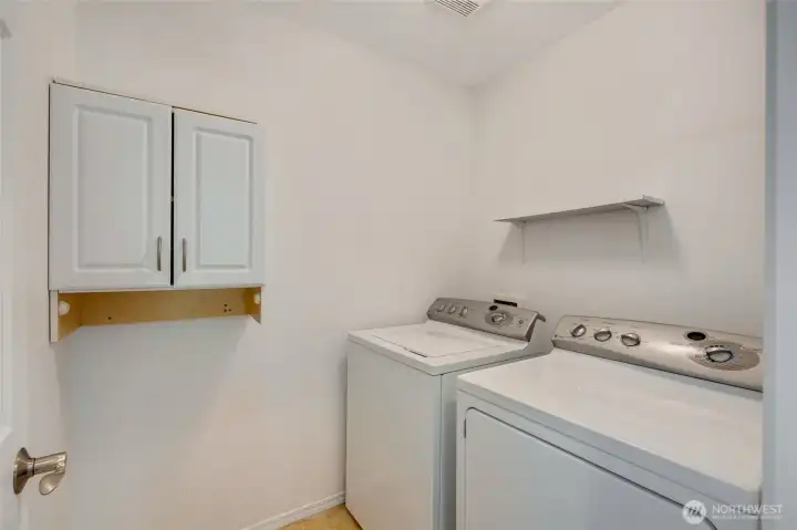 Utility room upstairs for added convenience.