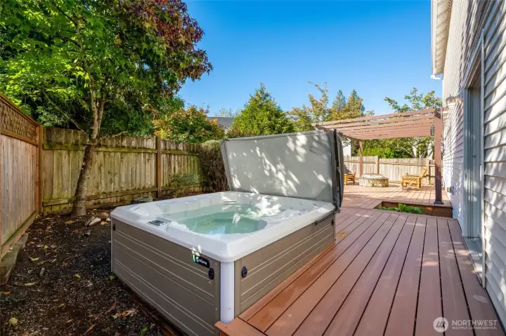 Relax in the bubbling hot tub or unwind around the fire pit under the pergola.
