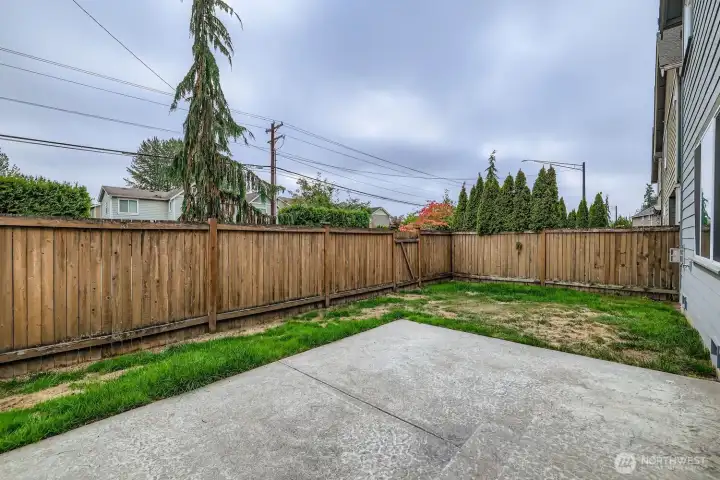 Fenced yard with stamped concrete patio