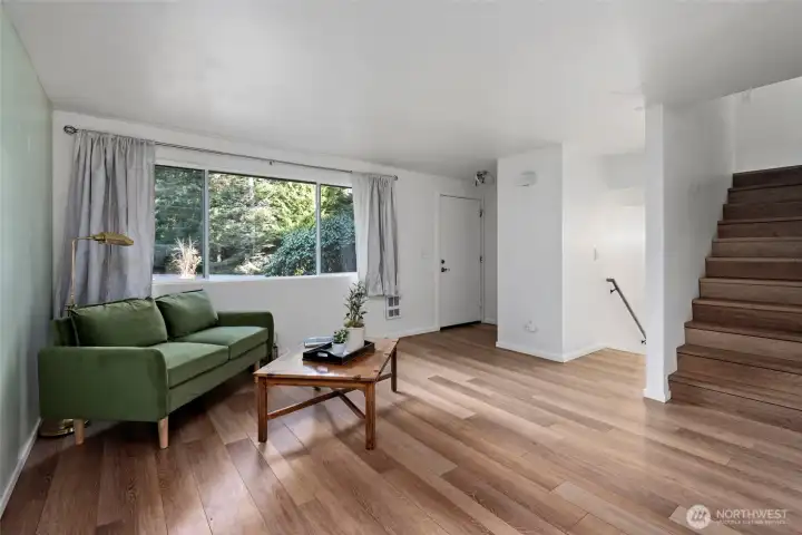 Front door into living room. Split level into upstairs primary and downstairs bedrooms.