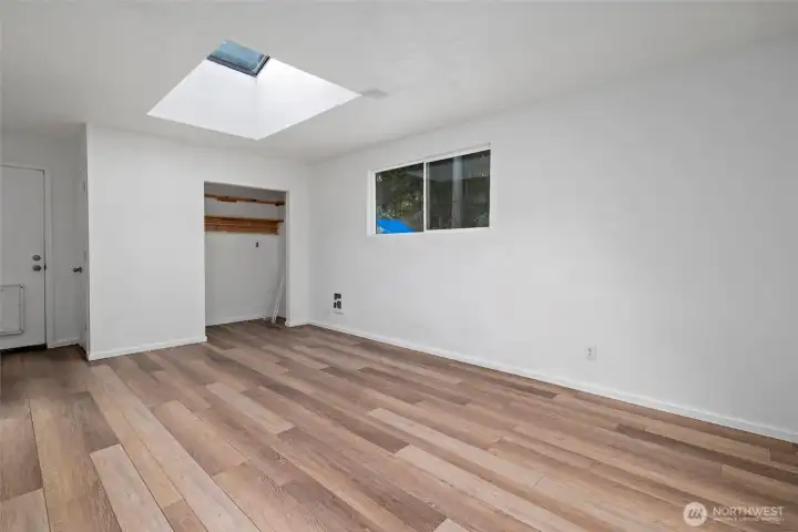 Family room with skylight and door to backyard.