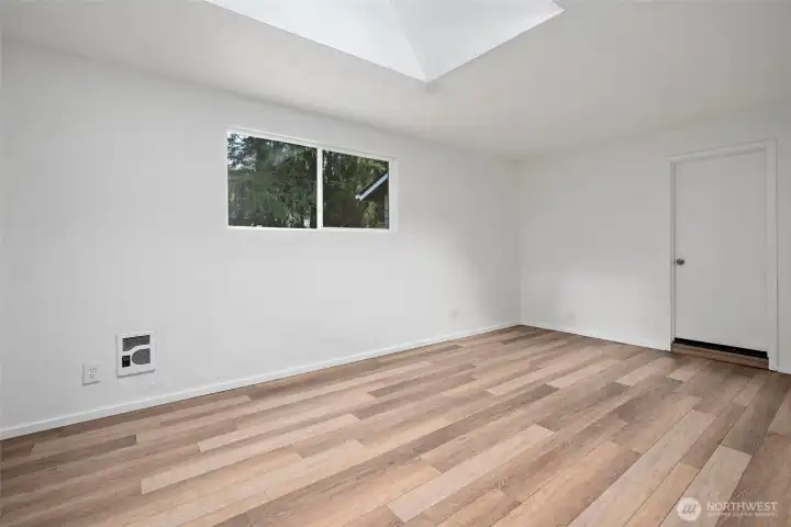 Family room with skylight and door to garage.