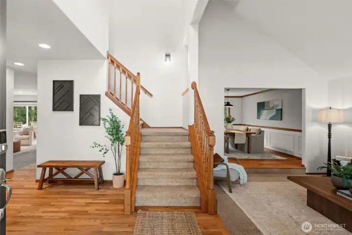 Stairs lead to all four bedrooms on the upper floor, with the formal living room on the right.