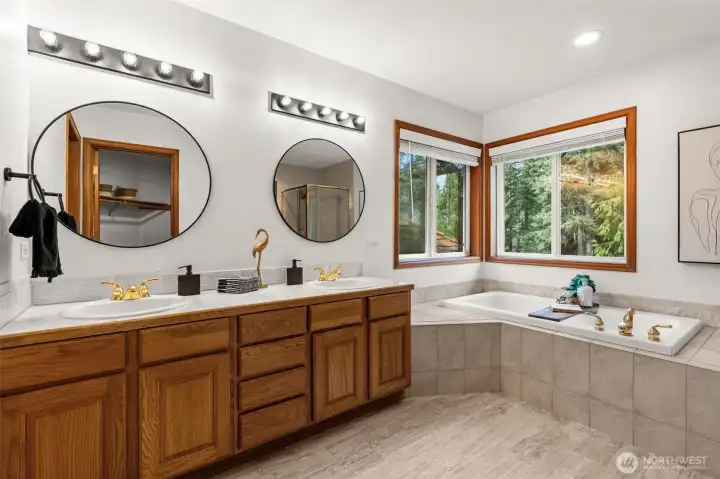 Primary bedroom ensuite full bathroom with updated fixtures, hardware, and mirrors.