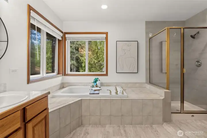 Primary bedroom ensuite full bathroom with updated fixtures, hardware, and mirrors.