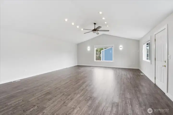 Massive Bonus/Family room with 1/2 bath. Endless possiblities, door leads to the back deck and huge shop.