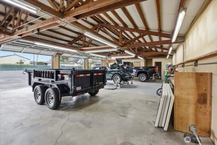 Shop interior--very roomy with 4 bay doors, 1/2 bath, small office space, work bench along the back wall with electrical and a Waste Oil Heater!