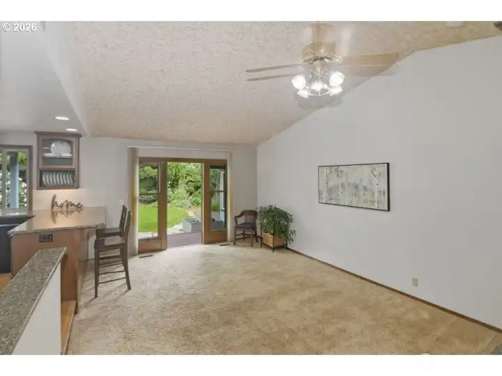 Sunk in living room with a door to backyard and deck.