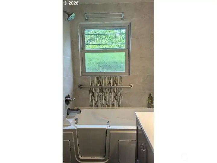 Walk in tub in primary bathroom.