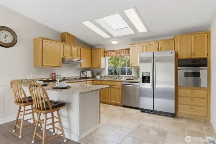 Spacious Kitchen with Granite Countertops  & Convenient Breakfast Bar