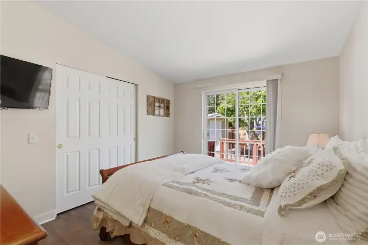 This second bedroom features a sliding glass door to a private deck.