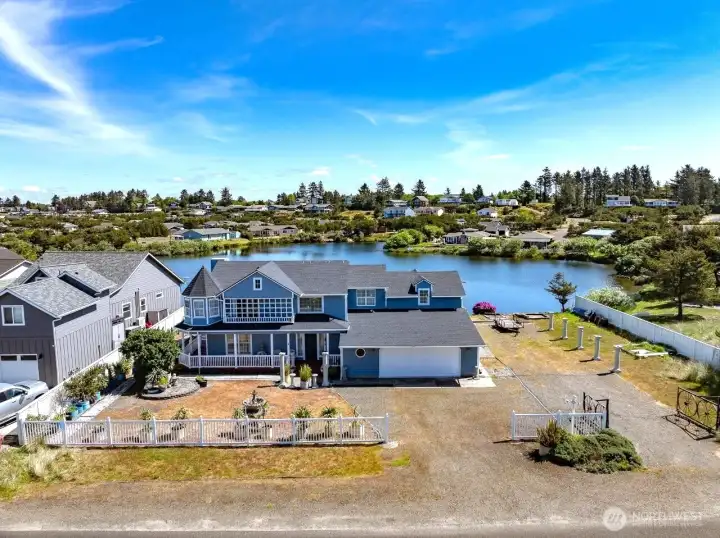 This exceptional home has the design, the size and location to make for luxurious living on a lake across from the Pacific Ocean.
